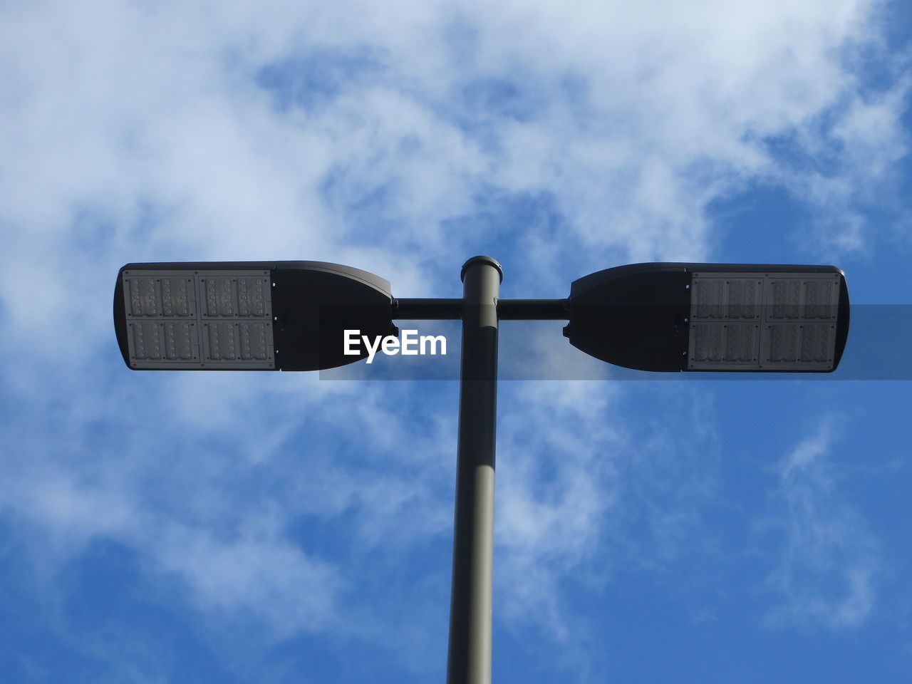 LOW ANGLE VIEW OF FLOODLIGHT AGAINST SKY