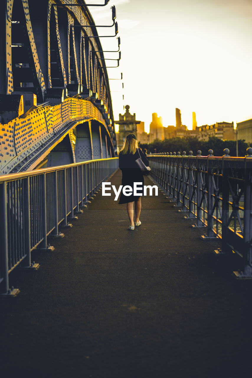 Woman walking on footbridge