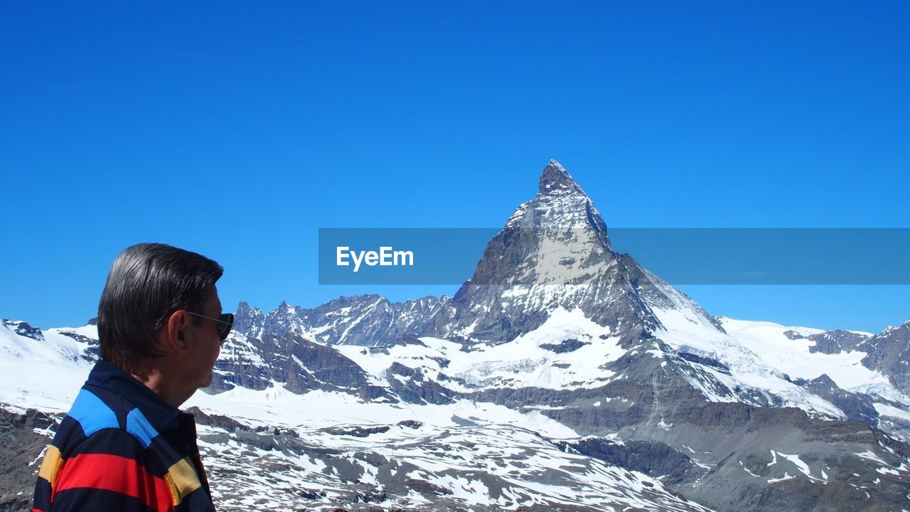 Man looking at snowcapped mountain 