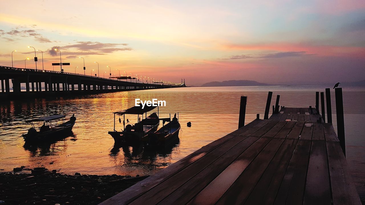 PIER OVER SEA DURING SUNSET