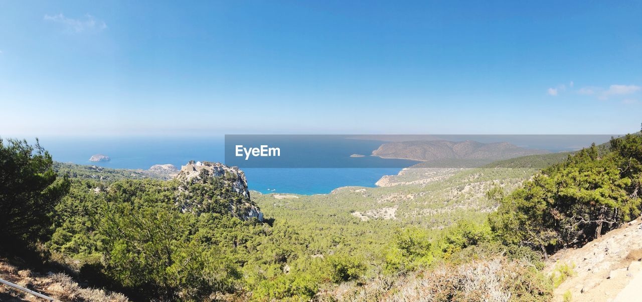 Scenic view of bay against clear blue sky