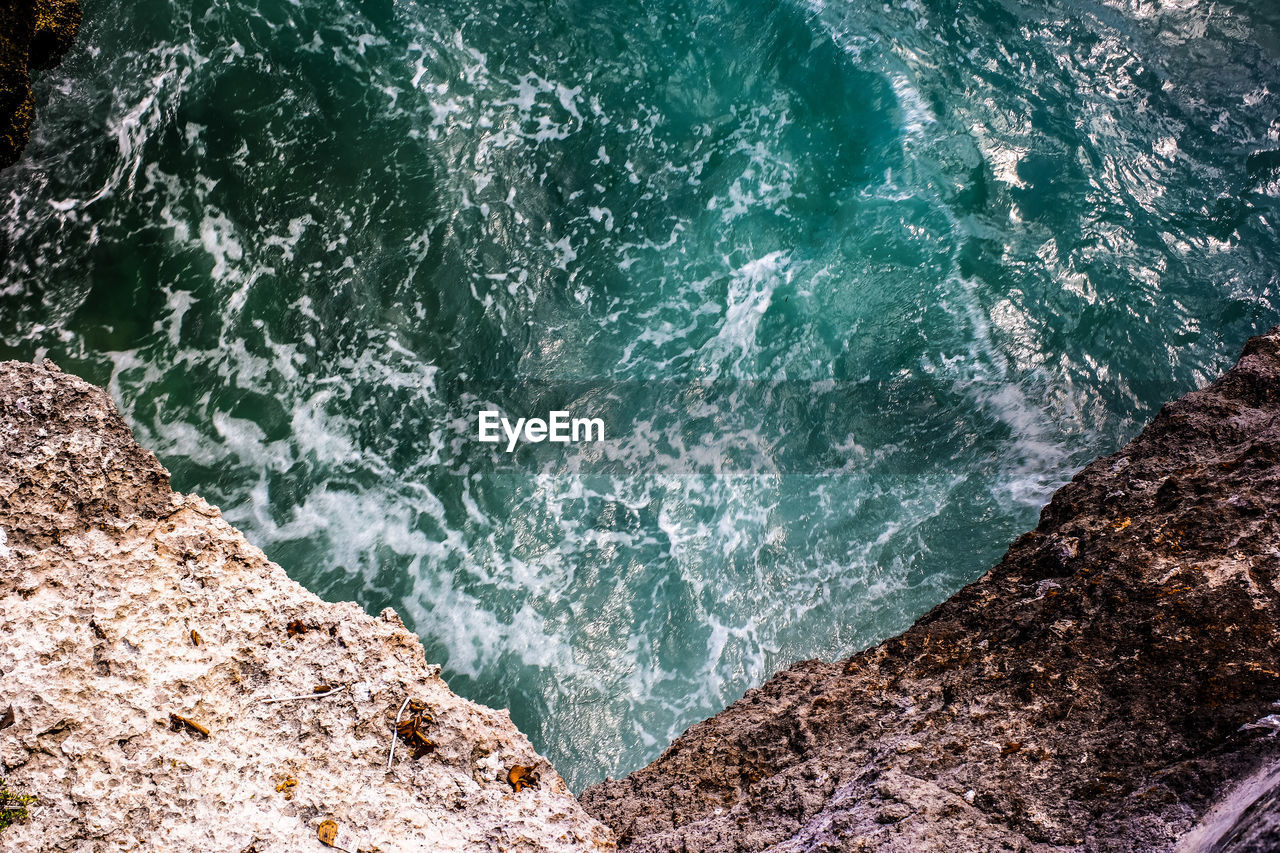 High angle view of rocks in sea