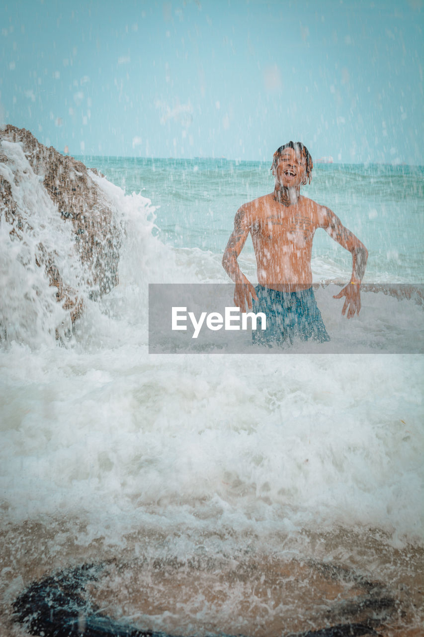 MAN SURFING IN SEA