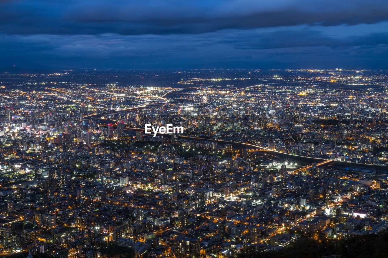 High angle view of illuminated city buildings at night