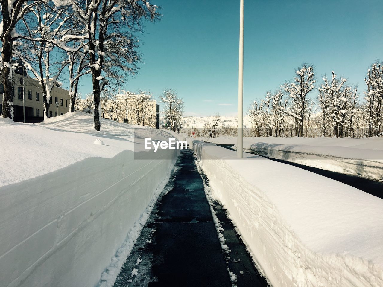 TIRE TRACKS IN WINTER AGAINST SKY