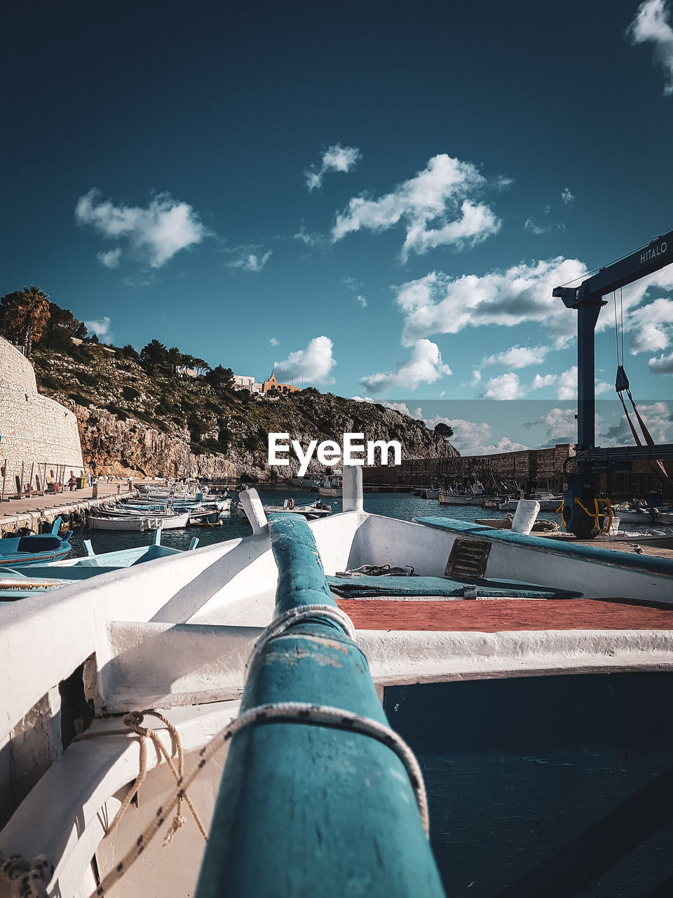 Low angle view of oar and boat against sky