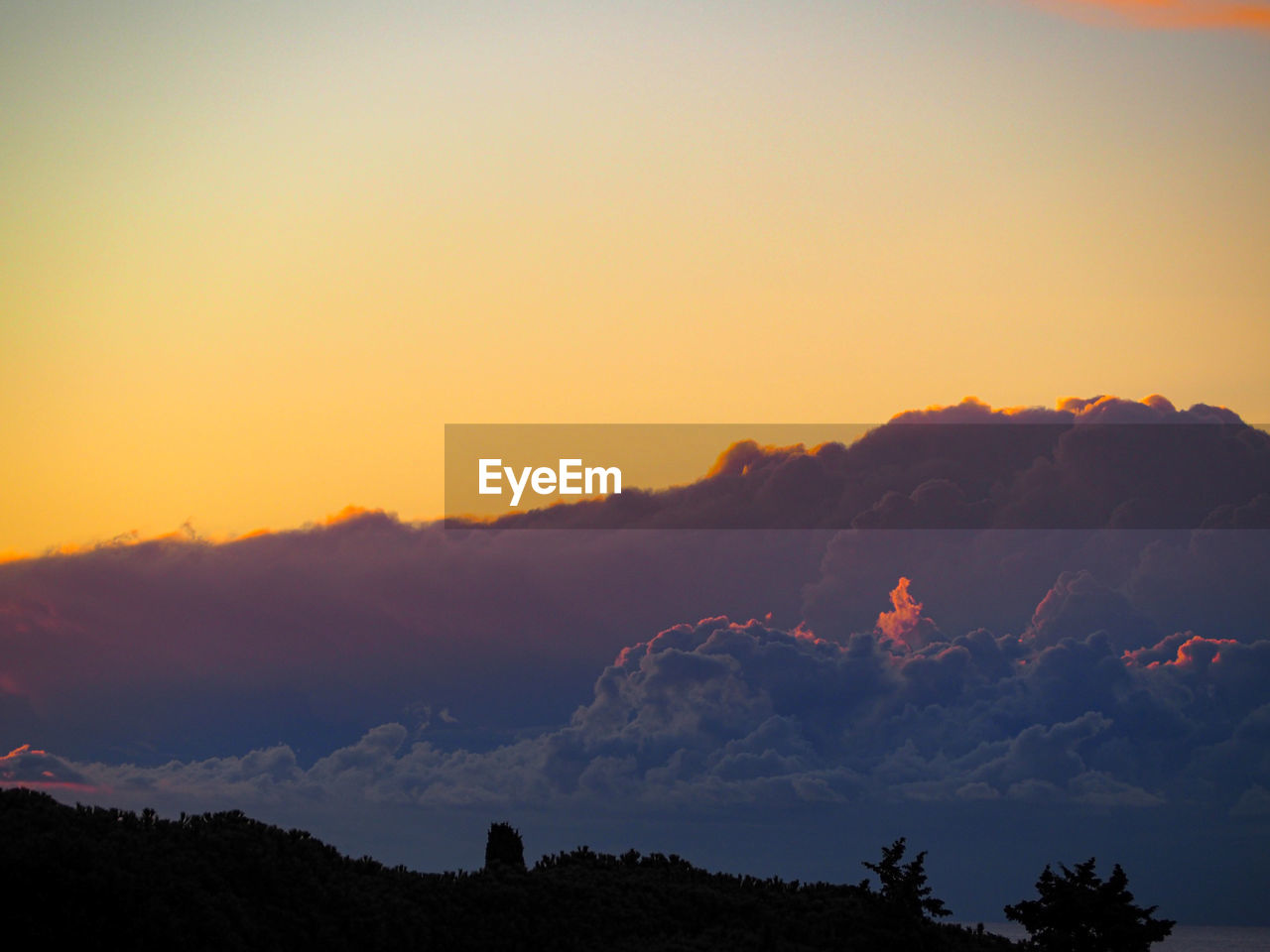 SCENIC VIEW OF SILHOUETTE MOUNTAINS AGAINST SKY AT SUNSET