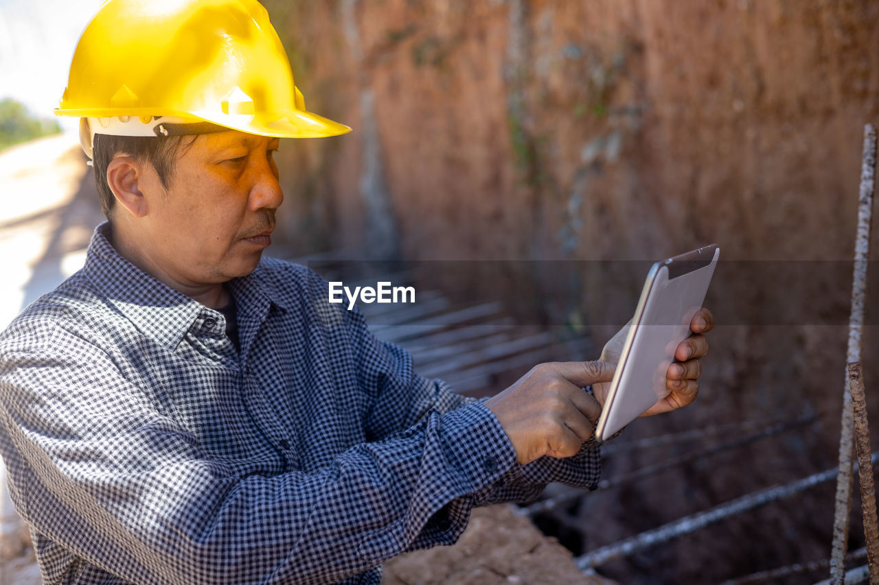 MAN WORKING ON MOBILE PHONE