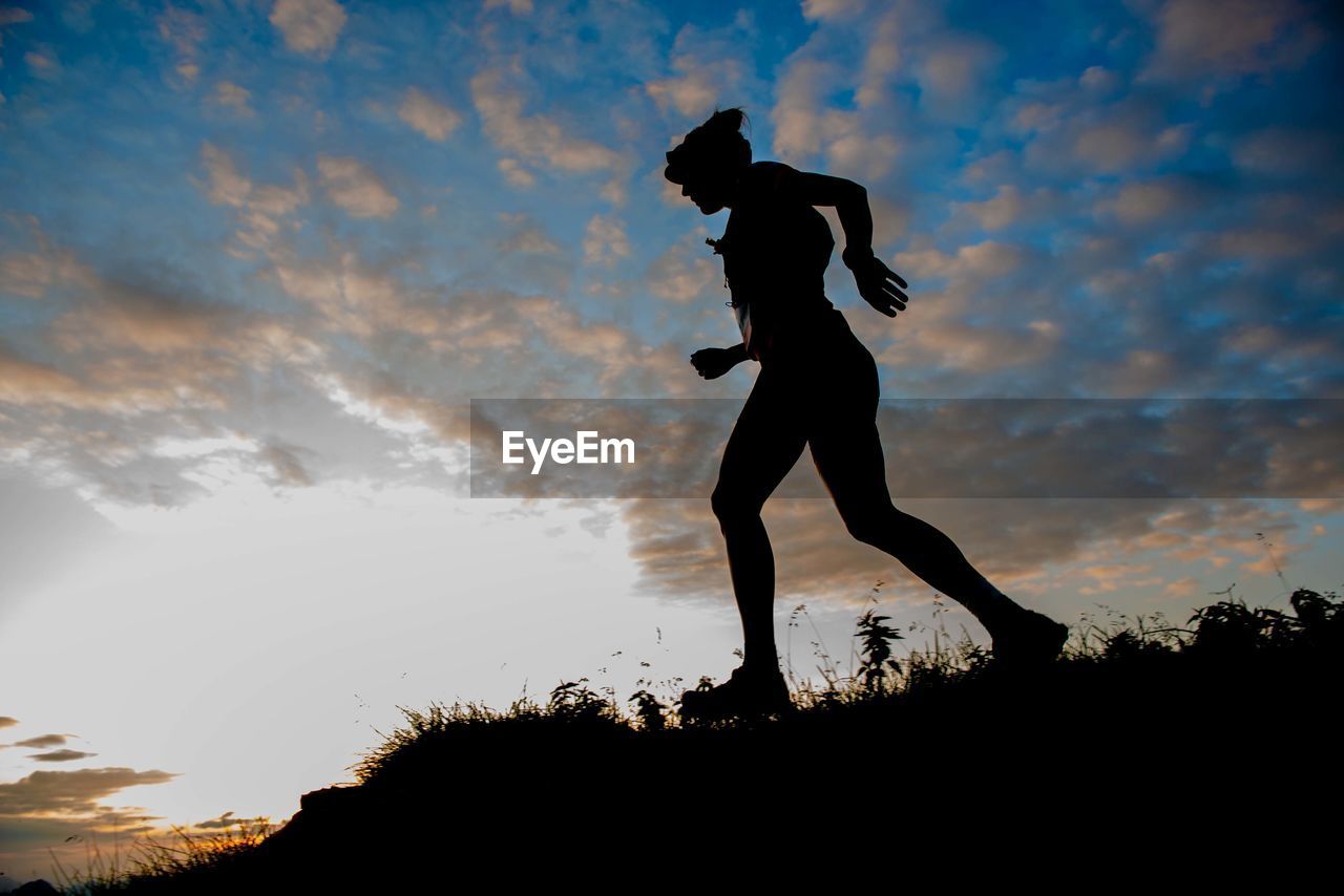 Low angle view of silhouette man against sky during sunset