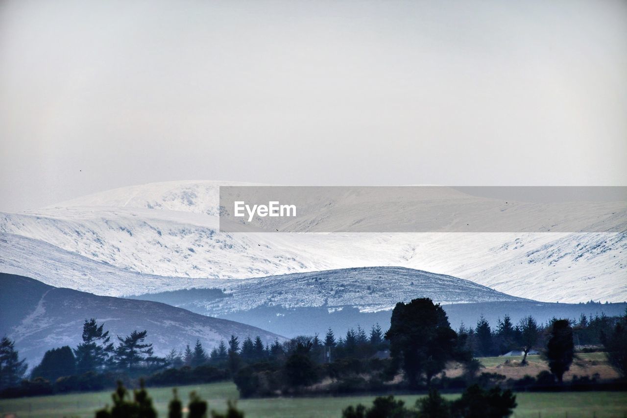 Tranquil view of snowcapped mountains against clear sky