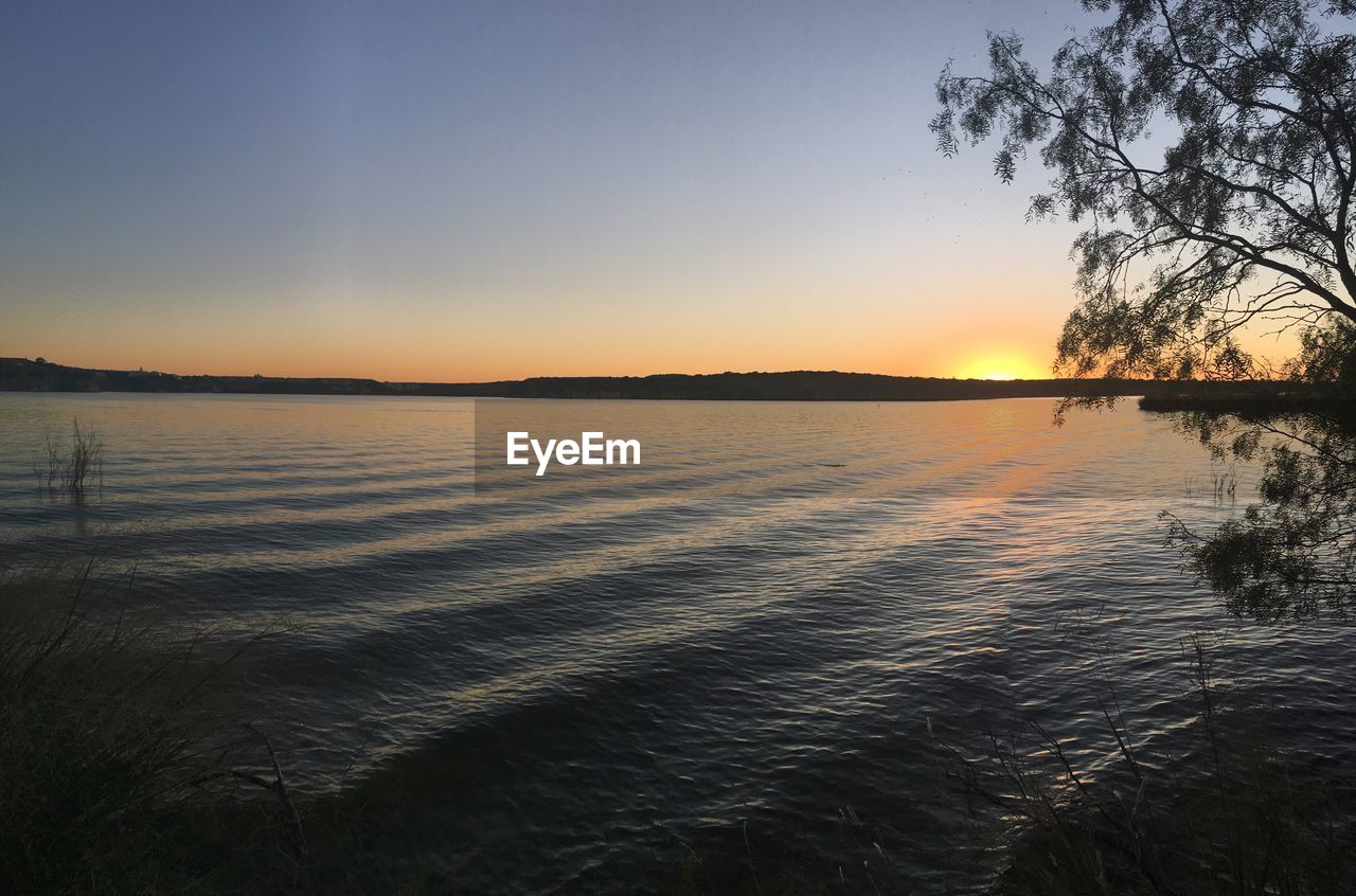 SCENIC VIEW OF LAKE DURING SUNSET