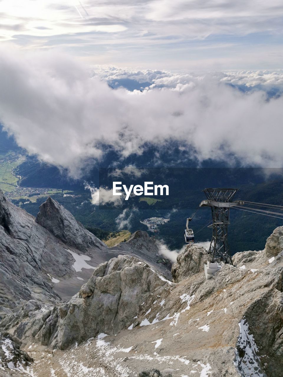 Aerial view of mountain range against cloudy sky