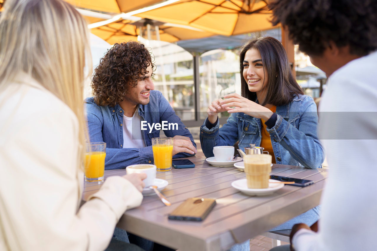 GROUP OF PEOPLE AT TABLE