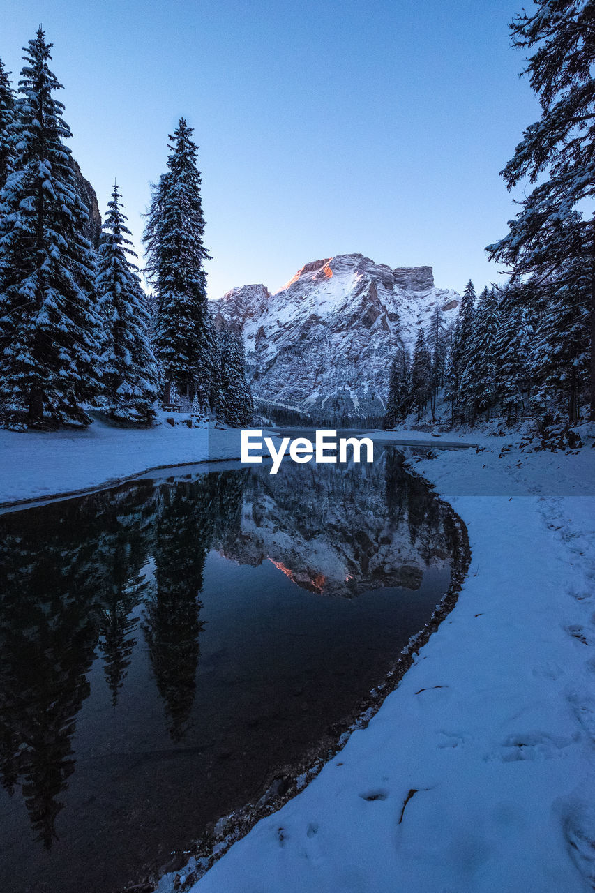 Scenic view of frozen lake against blue sky