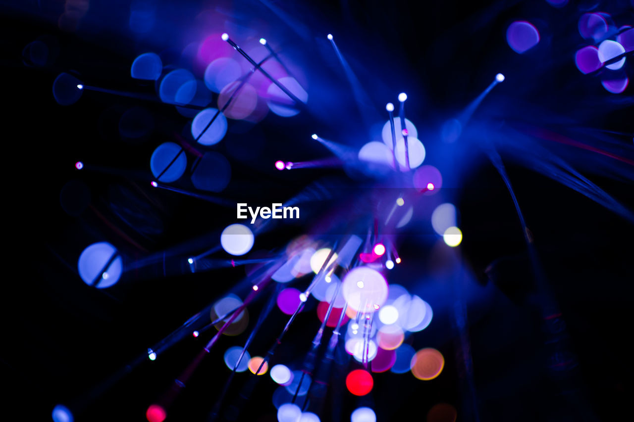 Colorful bokeh purple light celebrate at night, defocus light abstract background.