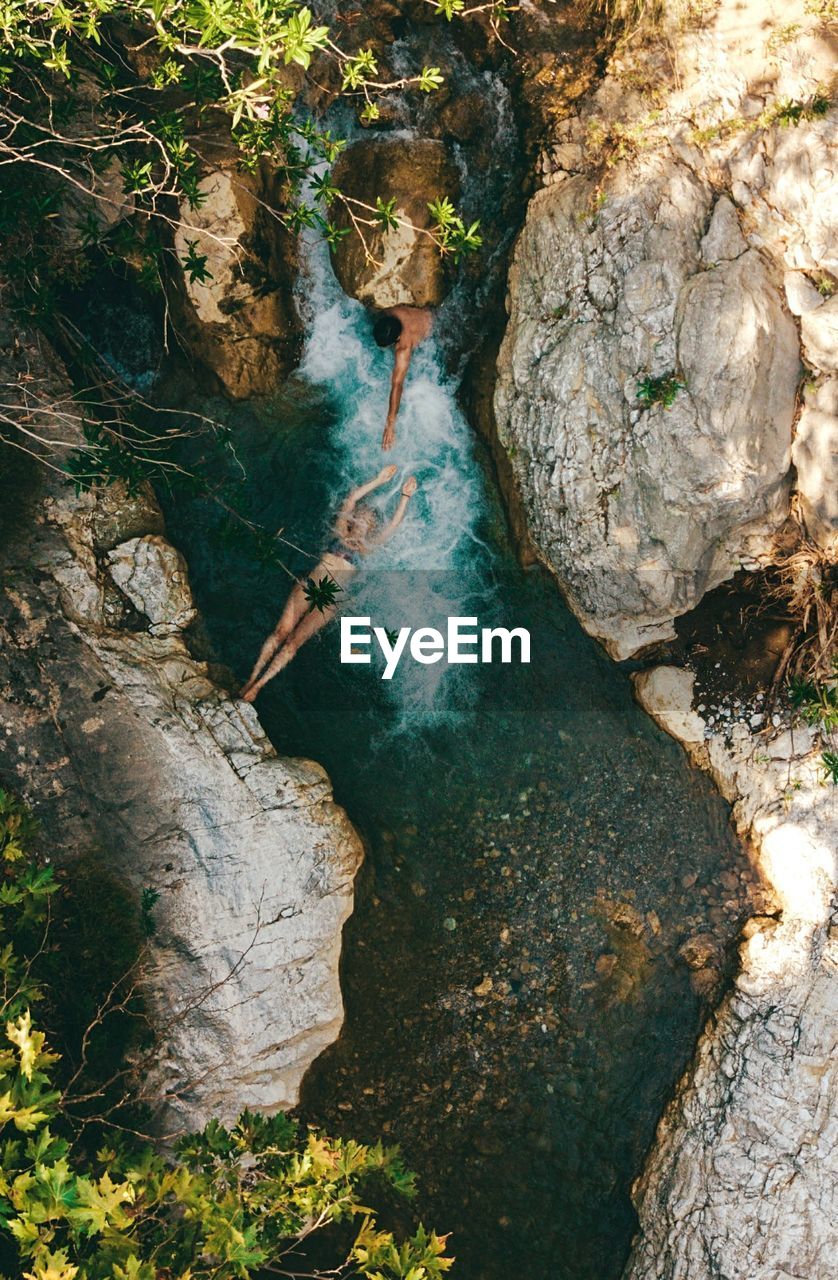 High angle view of couple swimming in river