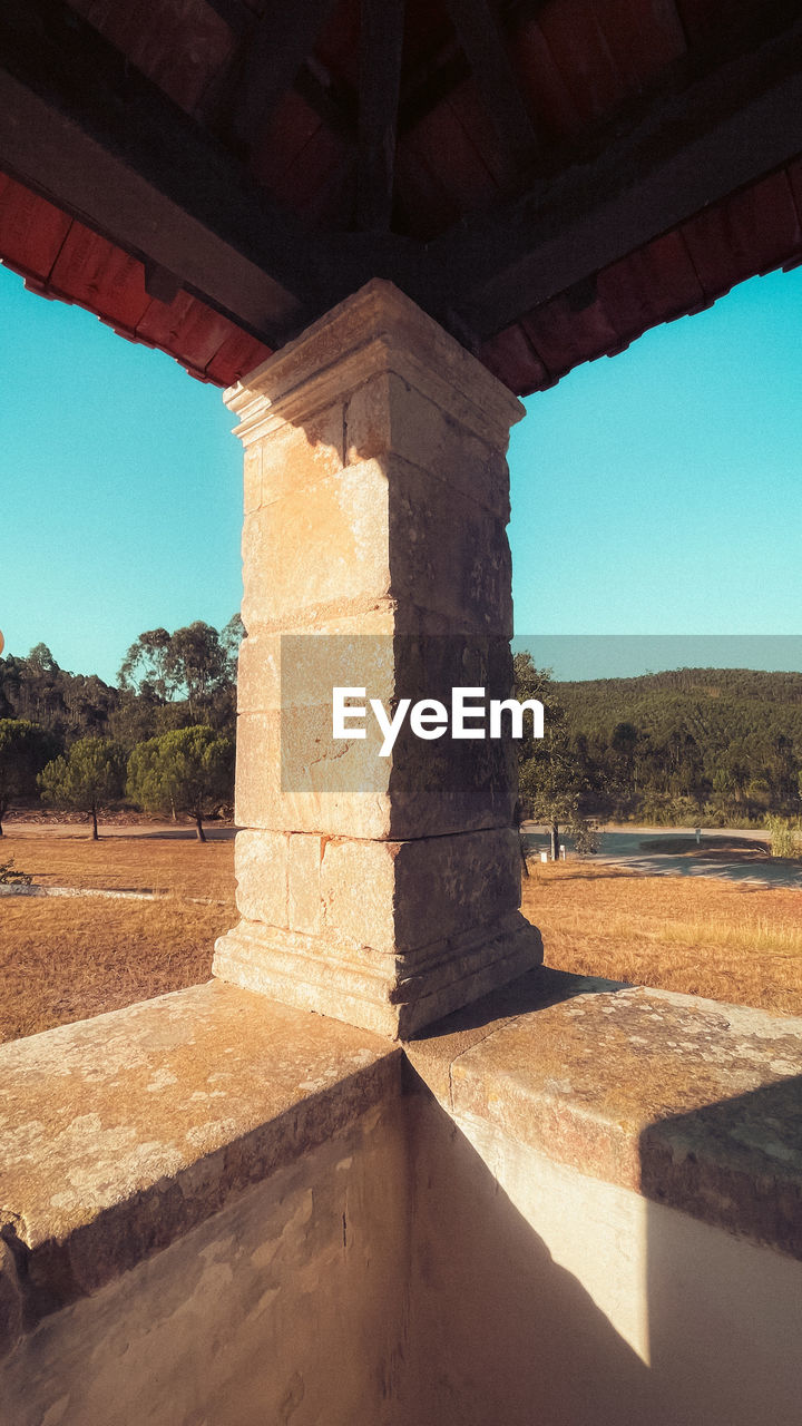 architecture, built structure, nature, ancient history, sky, no people, wood, arch, history, day, clear sky, architectural column, sunlight, travel destinations, the past, landscape, wall, temple, travel, sunny, outdoors, land, column, ancient, blue, water, scenics - nature, environment