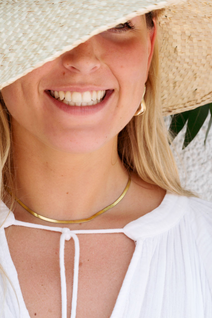Close up of a woman wearing straw hat