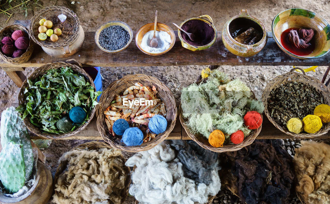 High angle view of various spices and cotton in whicker basket