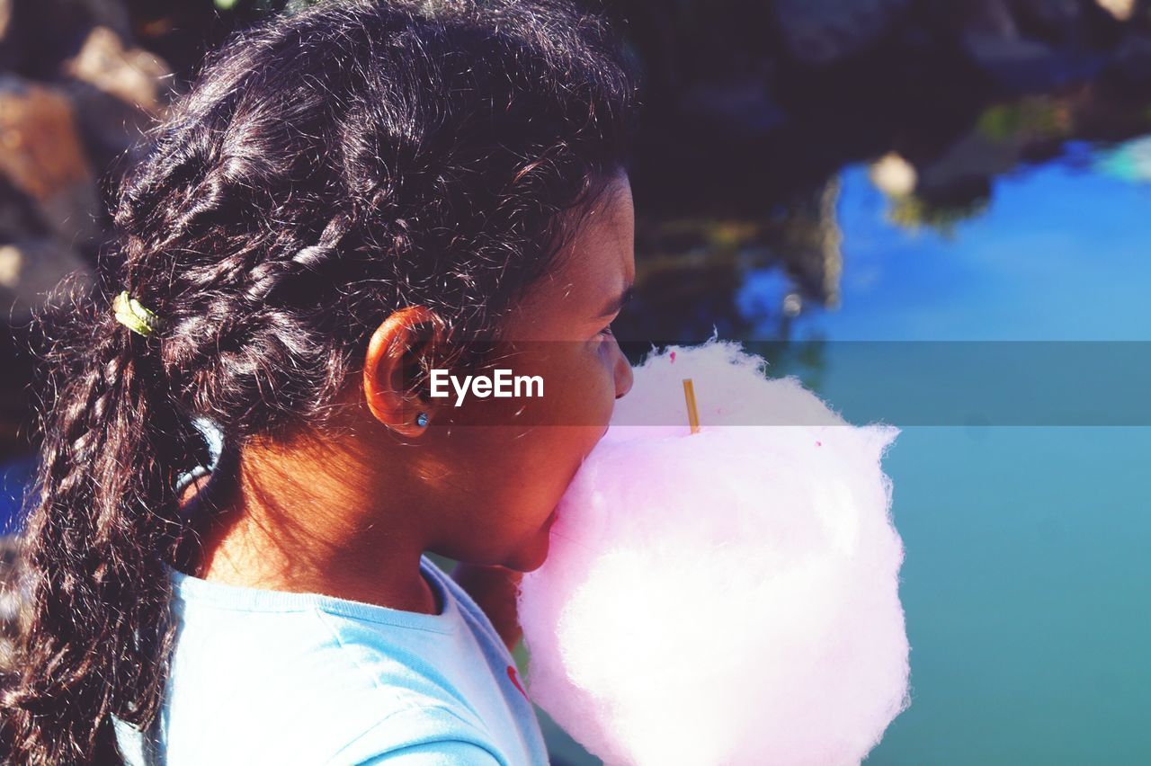 Close-up of girl eating cotton candy