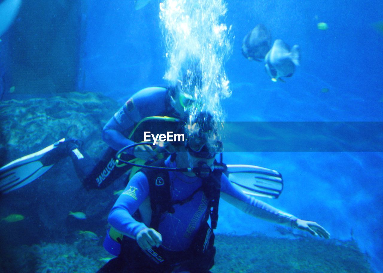 UNDERWATER VIEW OF SCUBA DIVING IN SEA