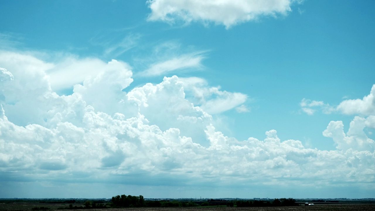 Landscape against blue sky and clouds
