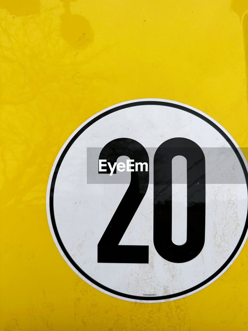 yellow, font, communication, sign, trademark, close-up, no people, vehicle registration plate, number, geometric shape, shape, symbol, metal, circle, black, wall - building feature, logo