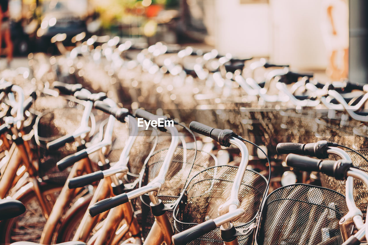 Close-up of bicycles parked side by side in city