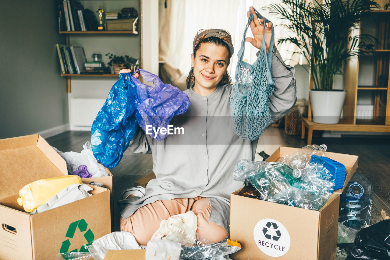 portrait of young woman sitting in box