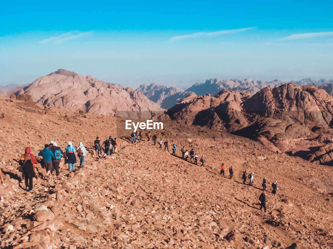 View of people in desert against blue sky