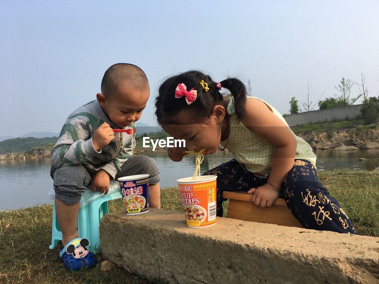 CHILDREN AND DAUGHTER AGAINST SKY