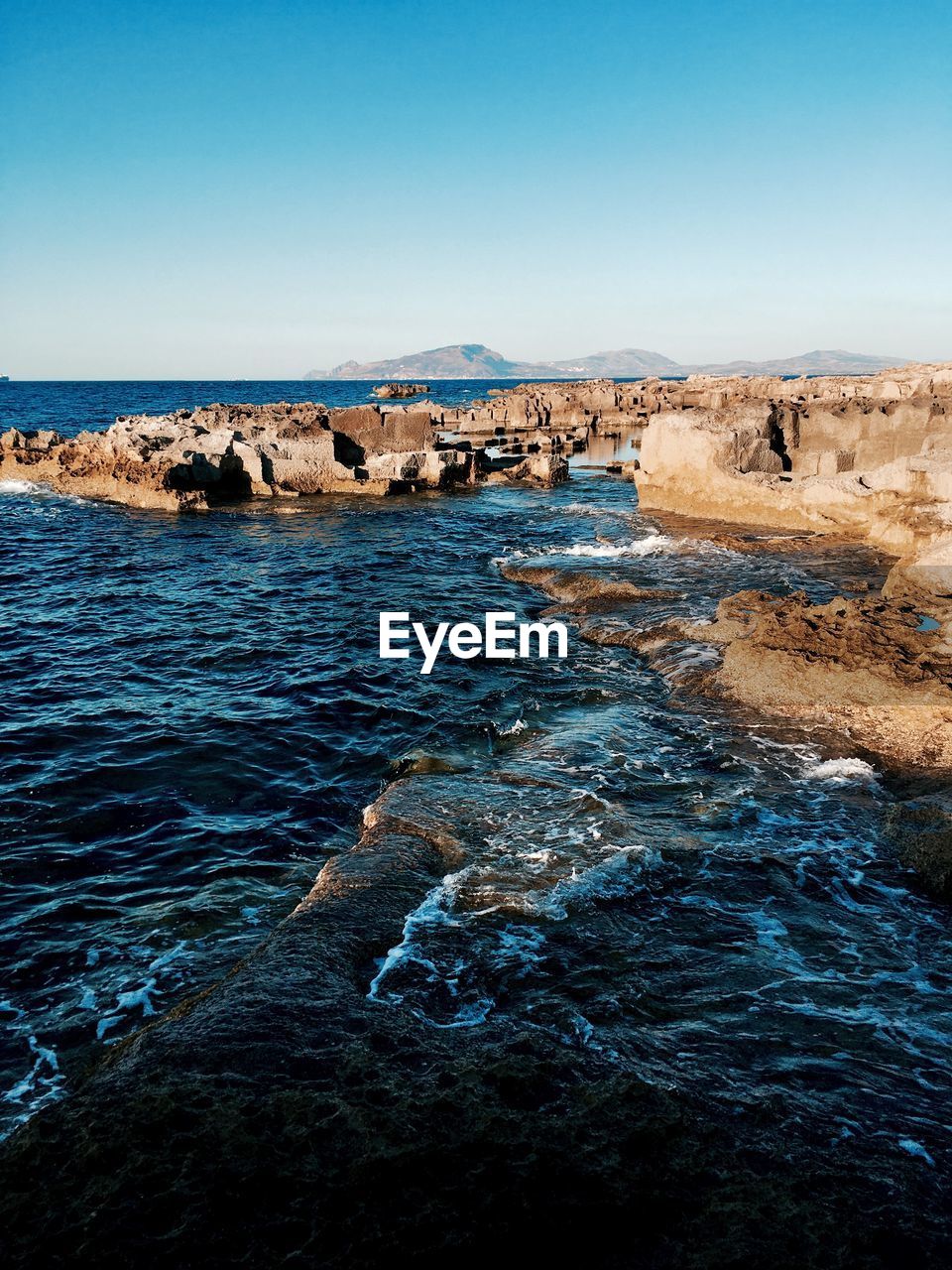 Scenic view of sea against clear blue sky