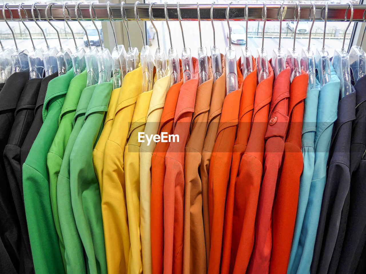 Multi colored clothes hanging in store