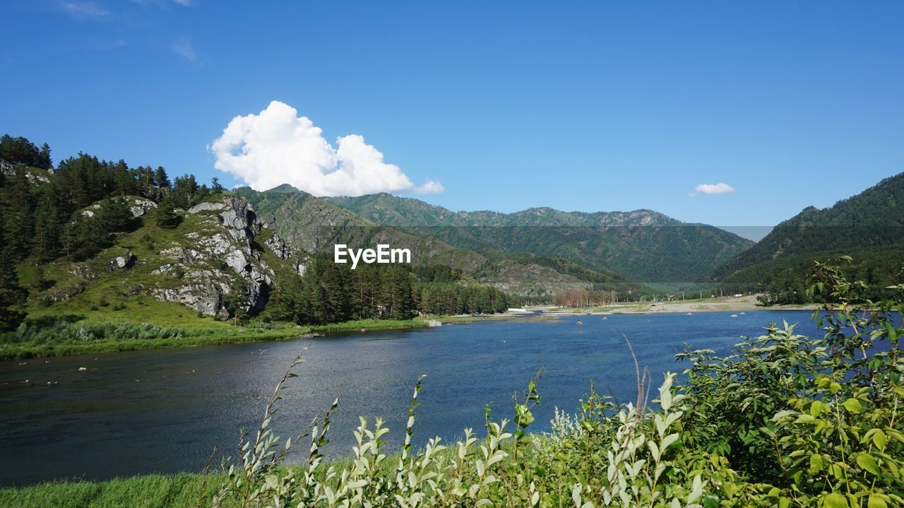 Scenic view of lake and mountains against sky