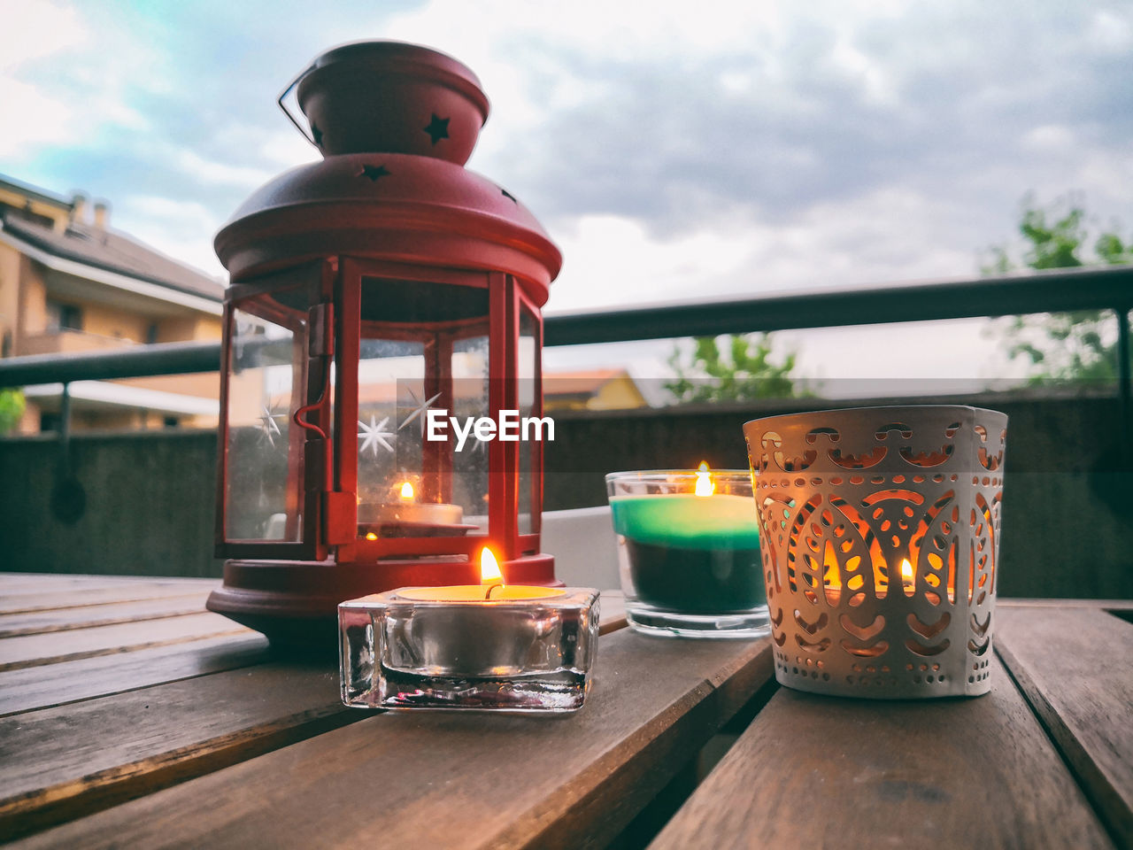 lighting, burning, fire, flame, nature, wood, heat, sky, candle, food and drink, architecture, table, no people, cloud, food, outdoors, lighting equipment, built structure, dusk, lantern, illuminated