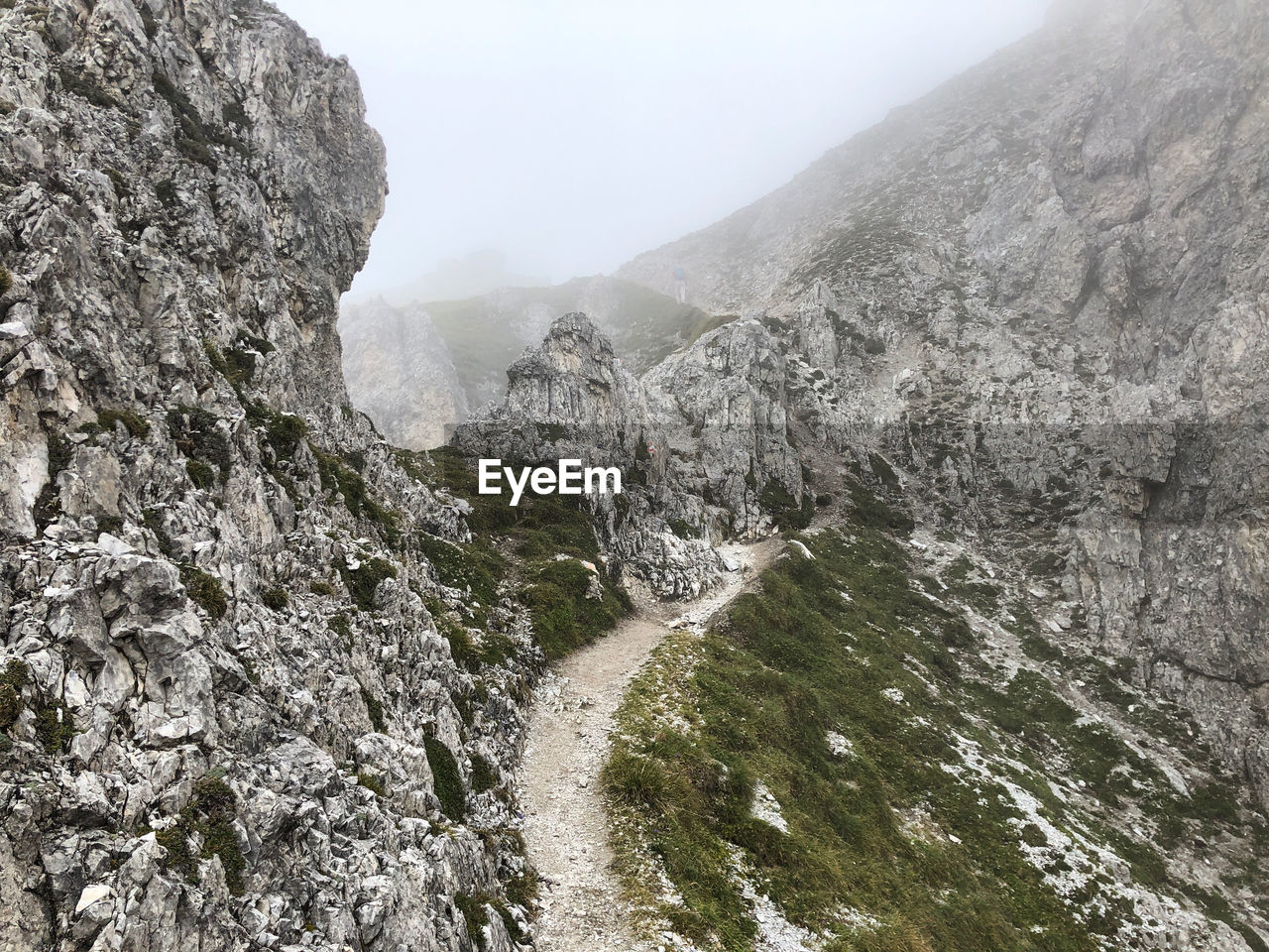 Scenic view of rocky mountains during foggy weather