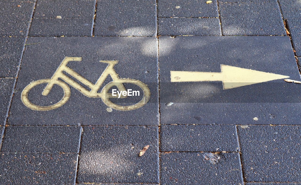 High angle view of sign on footpath