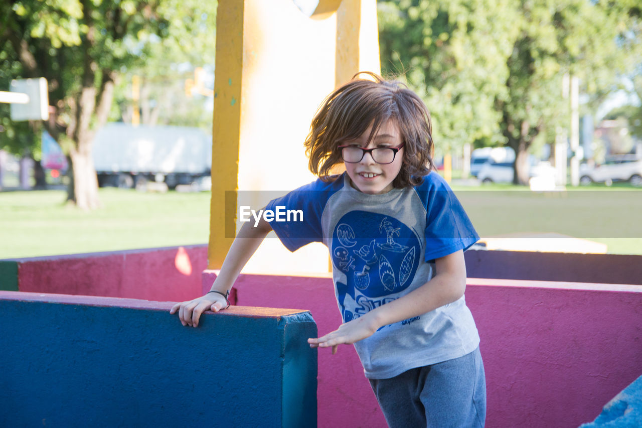 Portrait of child running in playground labyrinth