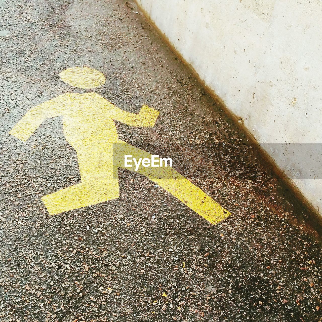 High angle view of yellow road marking on sidewalk