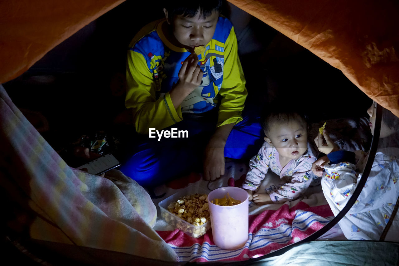 High angle view of children sitting in tent