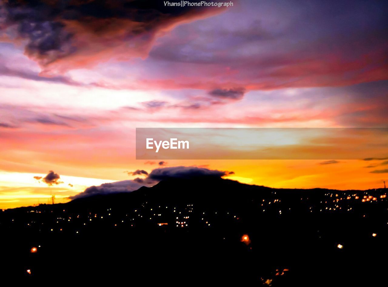 SILHOUETTE MOUNTAINS AGAINST DRAMATIC SKY DURING SUNSET