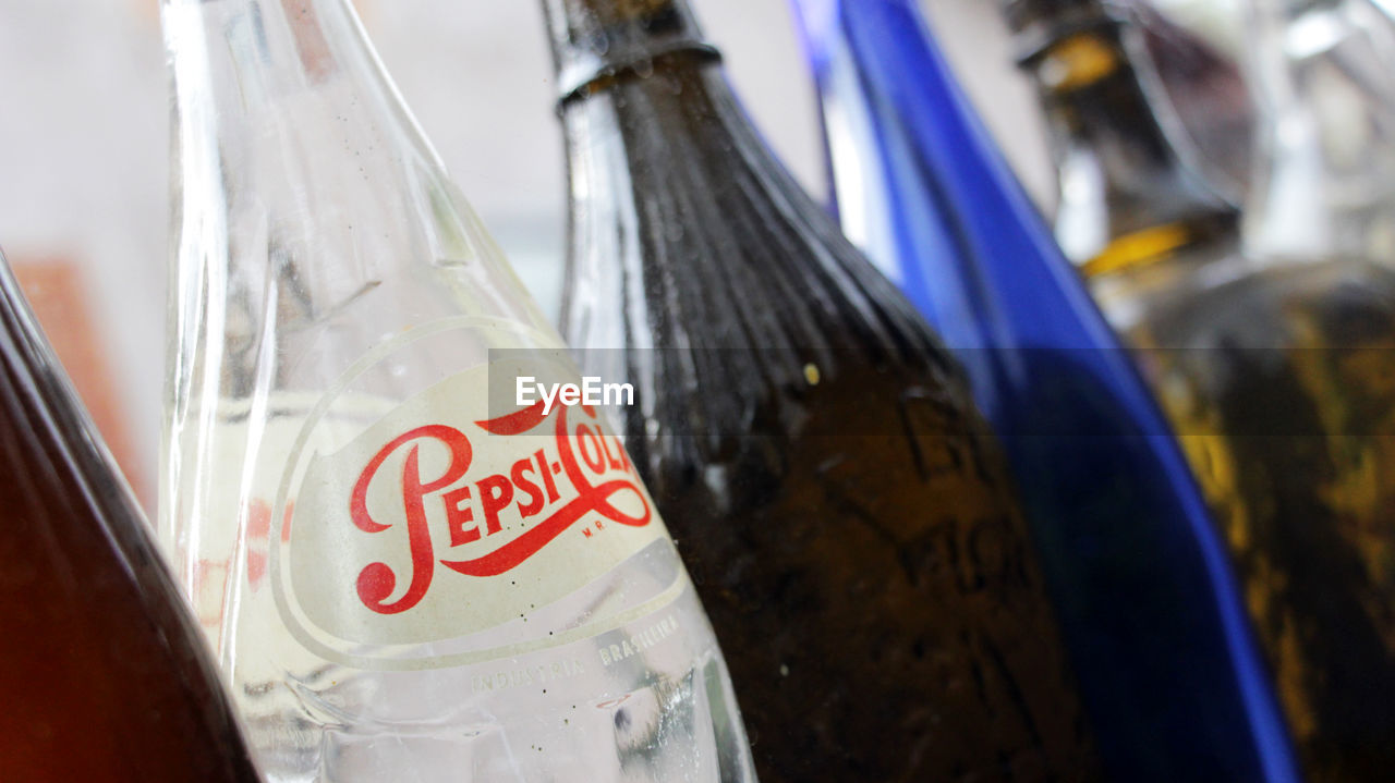 CLOSE-UP OF BEER BOTTLE WITH BOTTLES