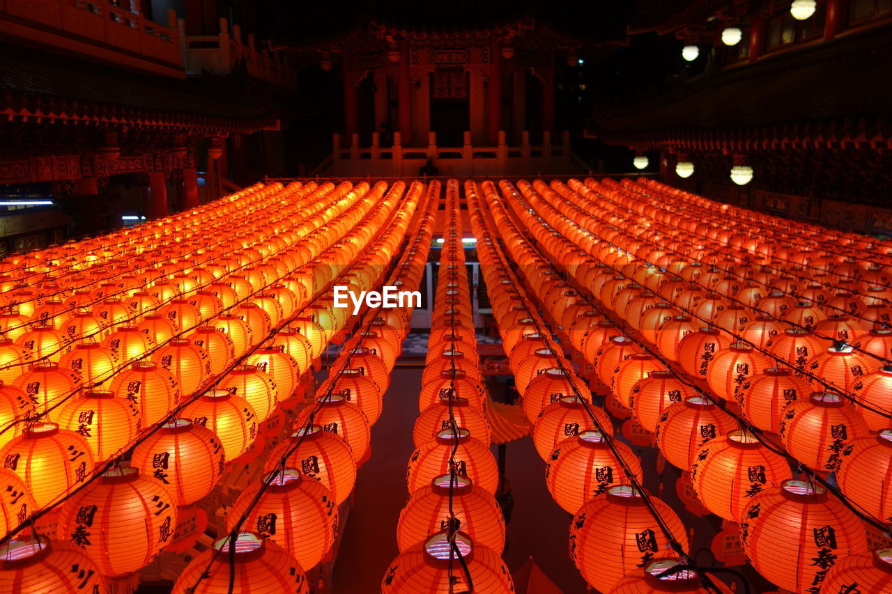 PANORAMIC VIEW OF EMPTY CHAIRS IN ILLUMINATED STAGE AT CONCERT