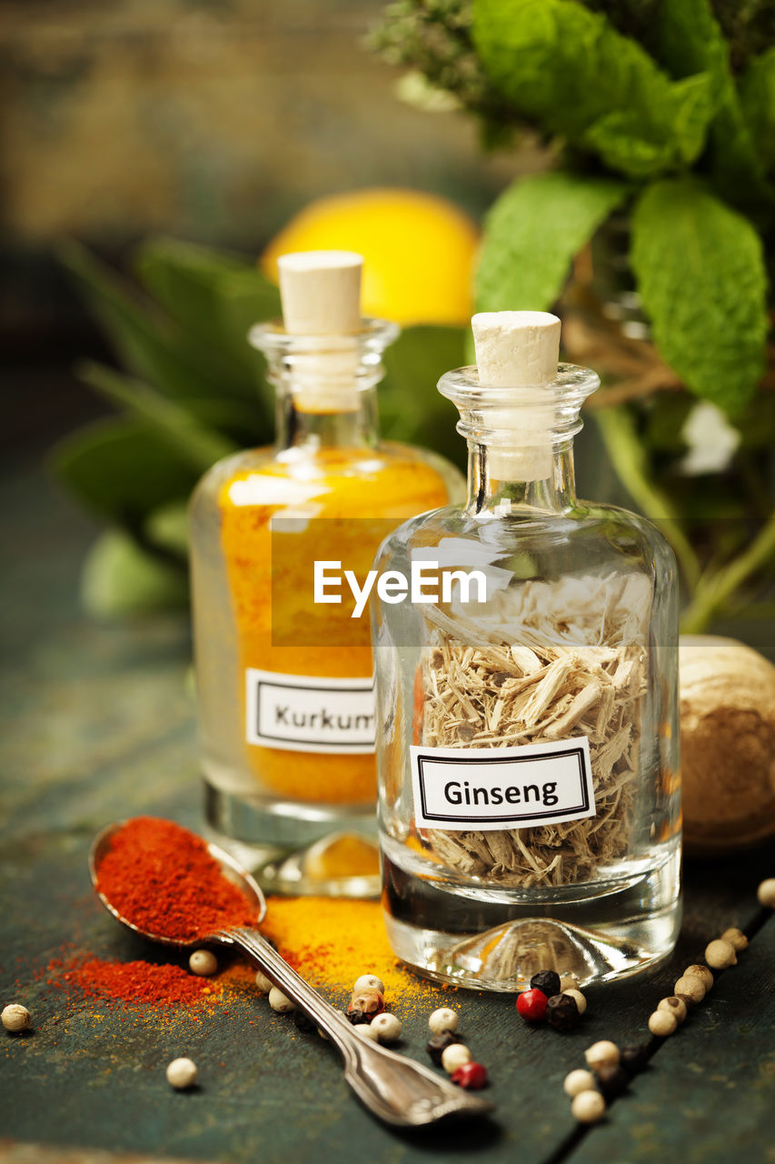 CLOSE-UP OF DRINK IN GLASS JAR ON BOTTLE