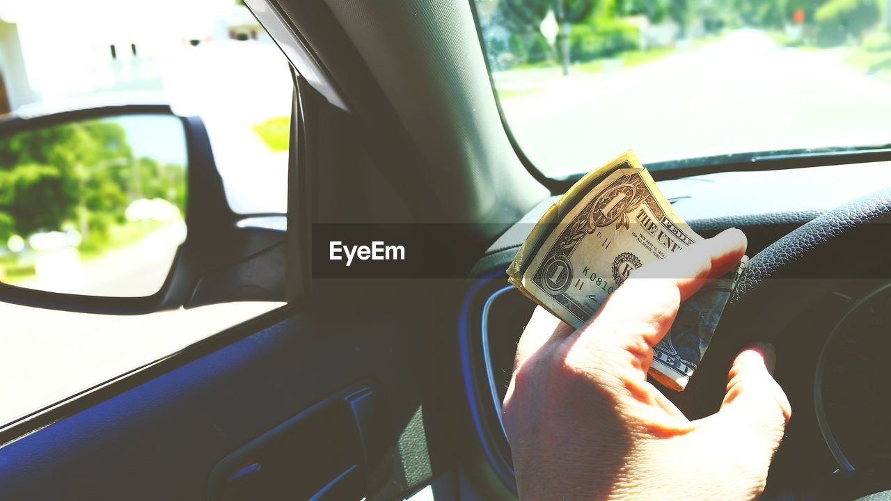 CLOSE-UP OF HAND HOLDING CAR