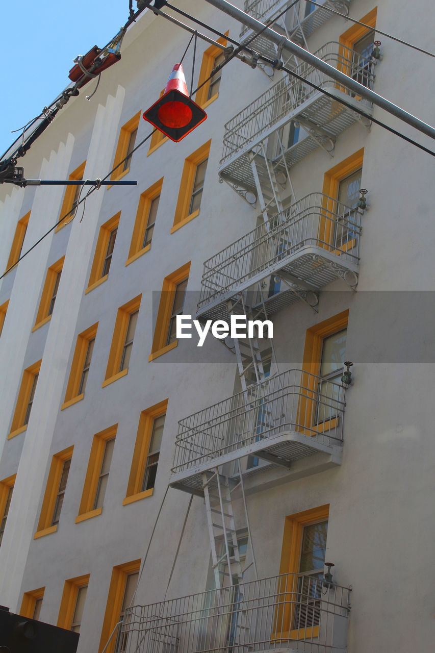 LOW ANGLE VIEW OF SPIRAL STAIRCASE IN CITY