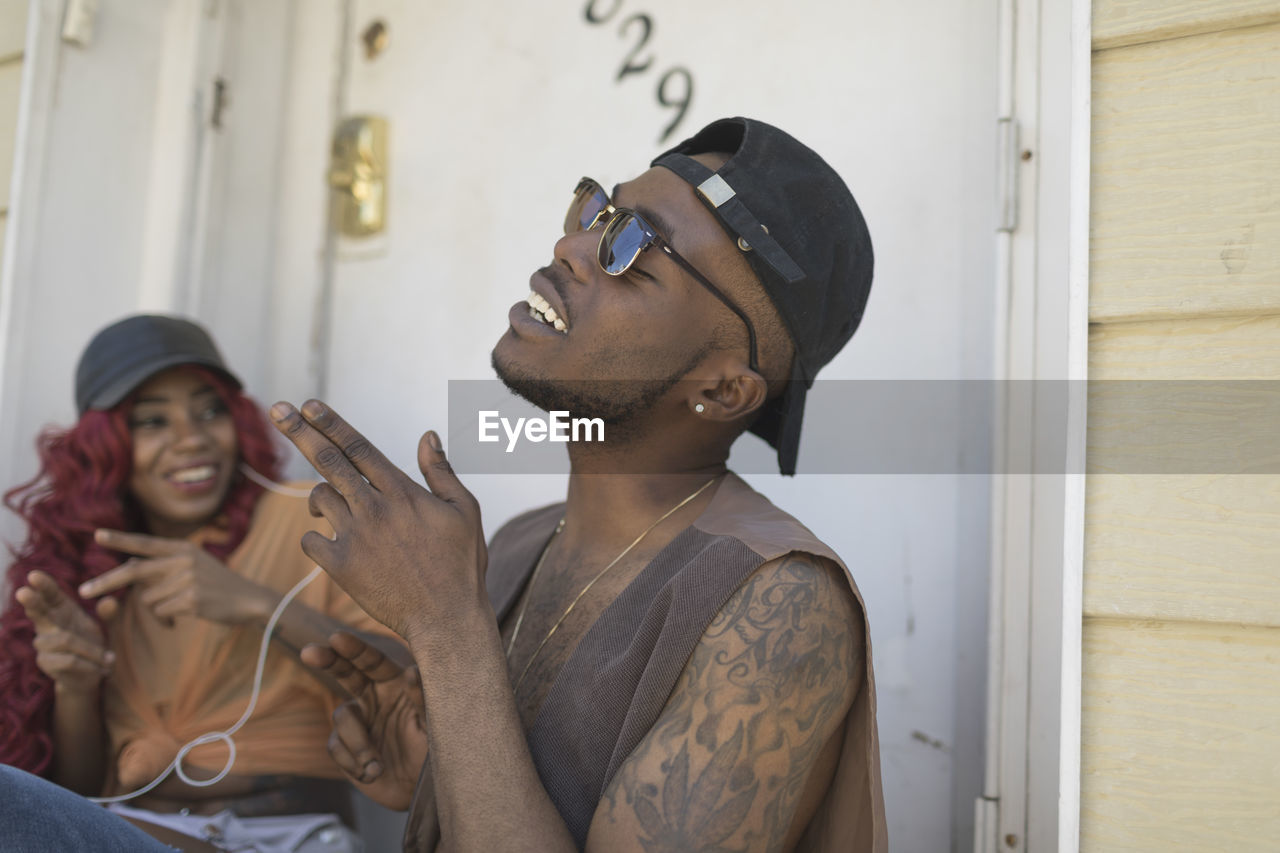 A couple in a music group listening to music at their front door