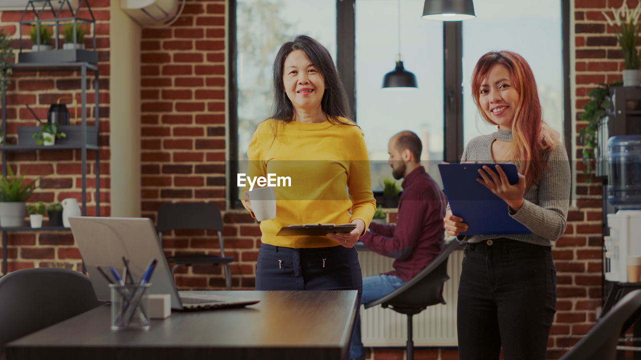 Portrait of smiling businesswomen at office