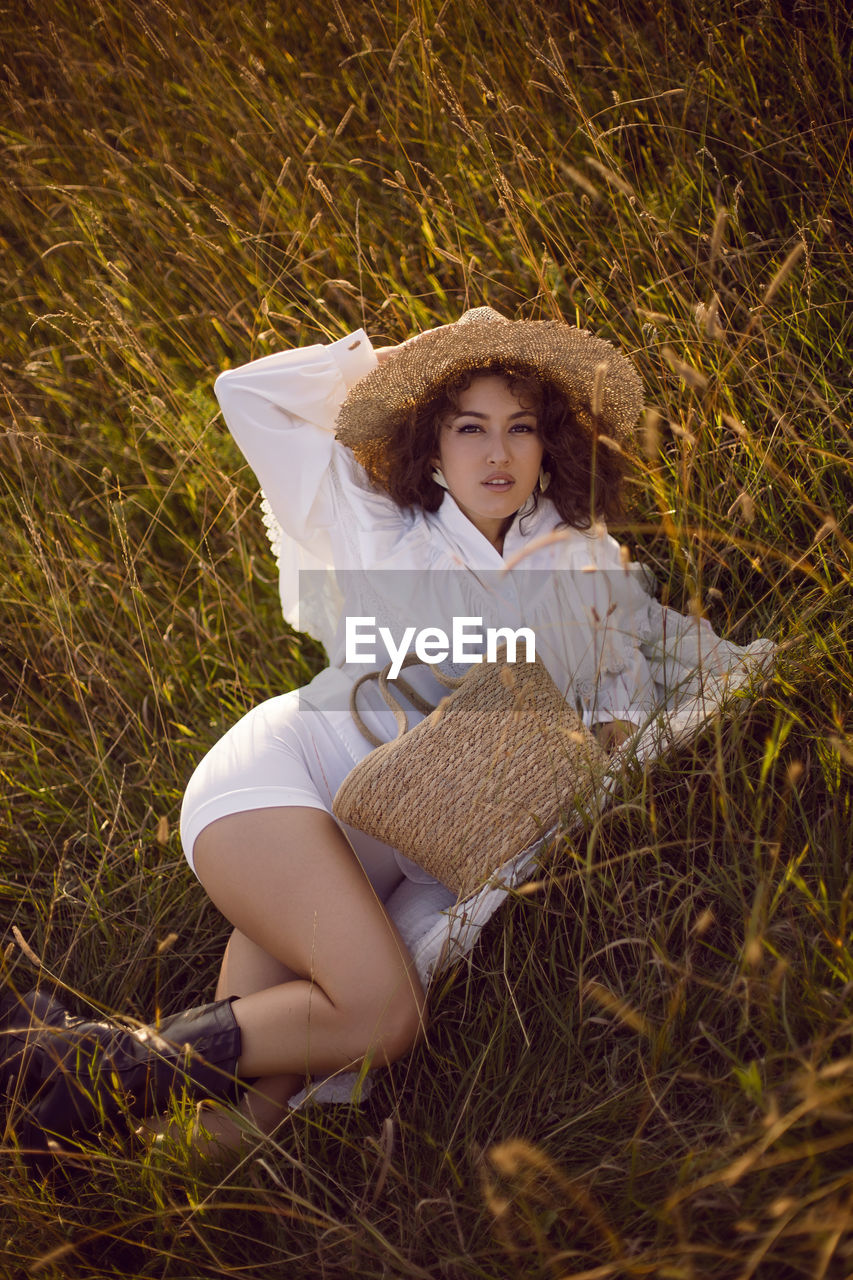  portrait woman in white clothes and in a wicker hat and with a basket  in autumn