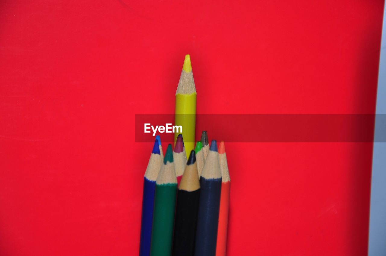 close-up of colored pencils against yellow background